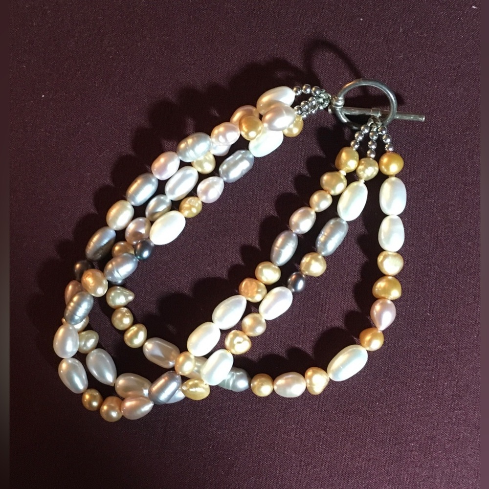 This bracelet is three strands of freshwater pearls